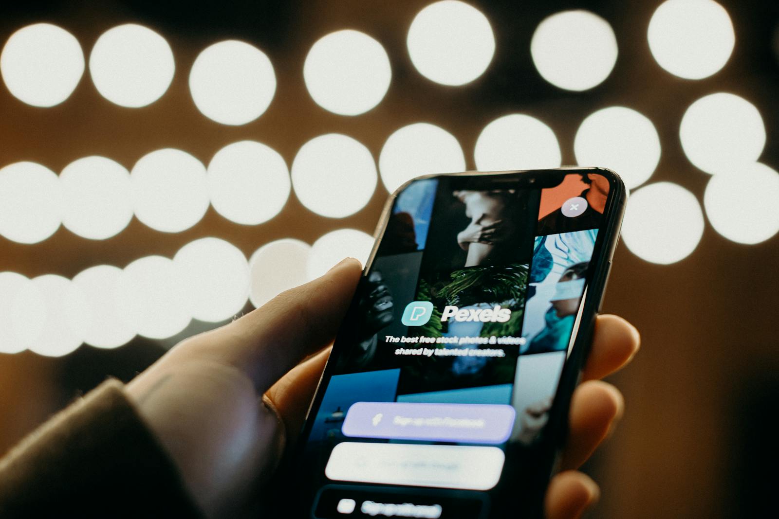 Close-up of a smartphone displaying an app interface with a blurred bokeh background for a modern tech feel.