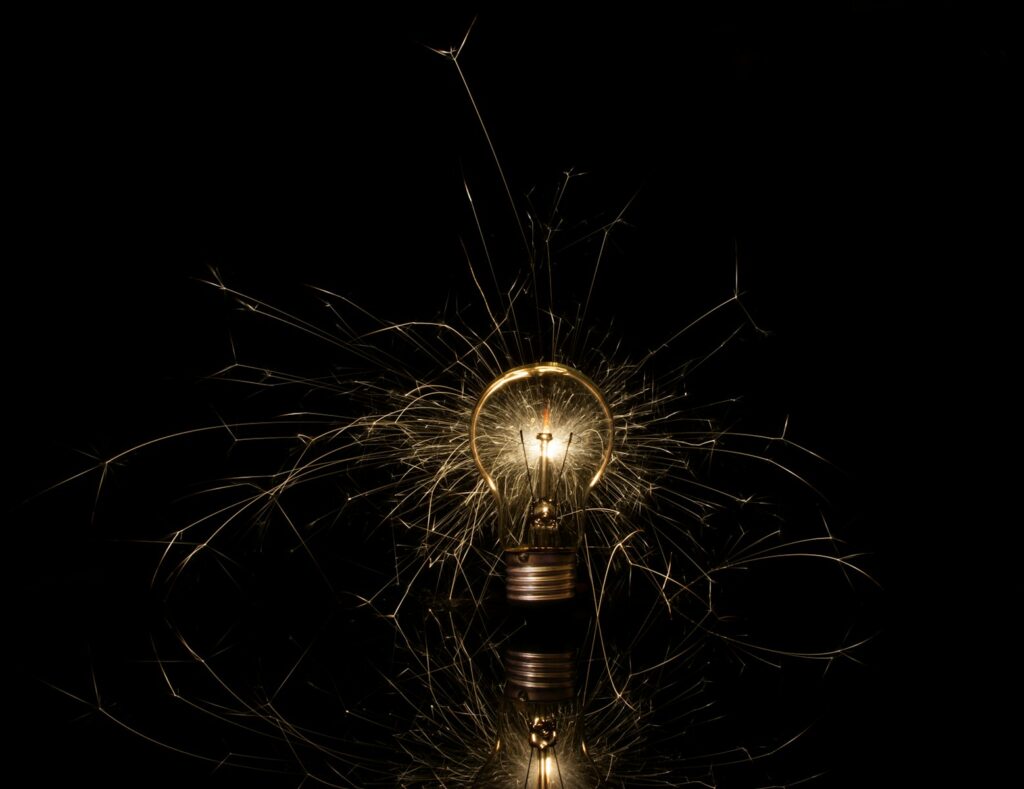 A light bulb that is lit up in the dark